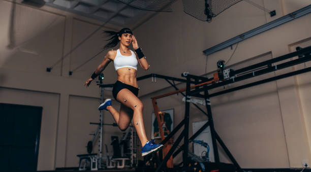 Female Athlete Jumping During Motion Analysis in a Sports Lab.